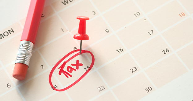 A calendar with a date circled and the word tax written on that date.