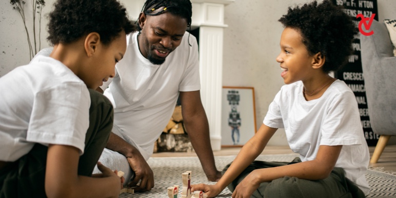 A dad and his two sons learn through play and make education fun by playing an educational money game together.