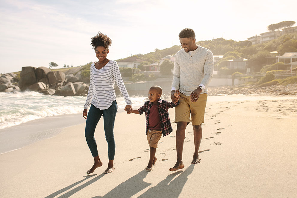 Mom and dad are walking on the beach on a hot summer's day.