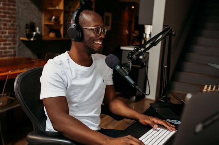 Young man wearing headphones working in a sound studio.