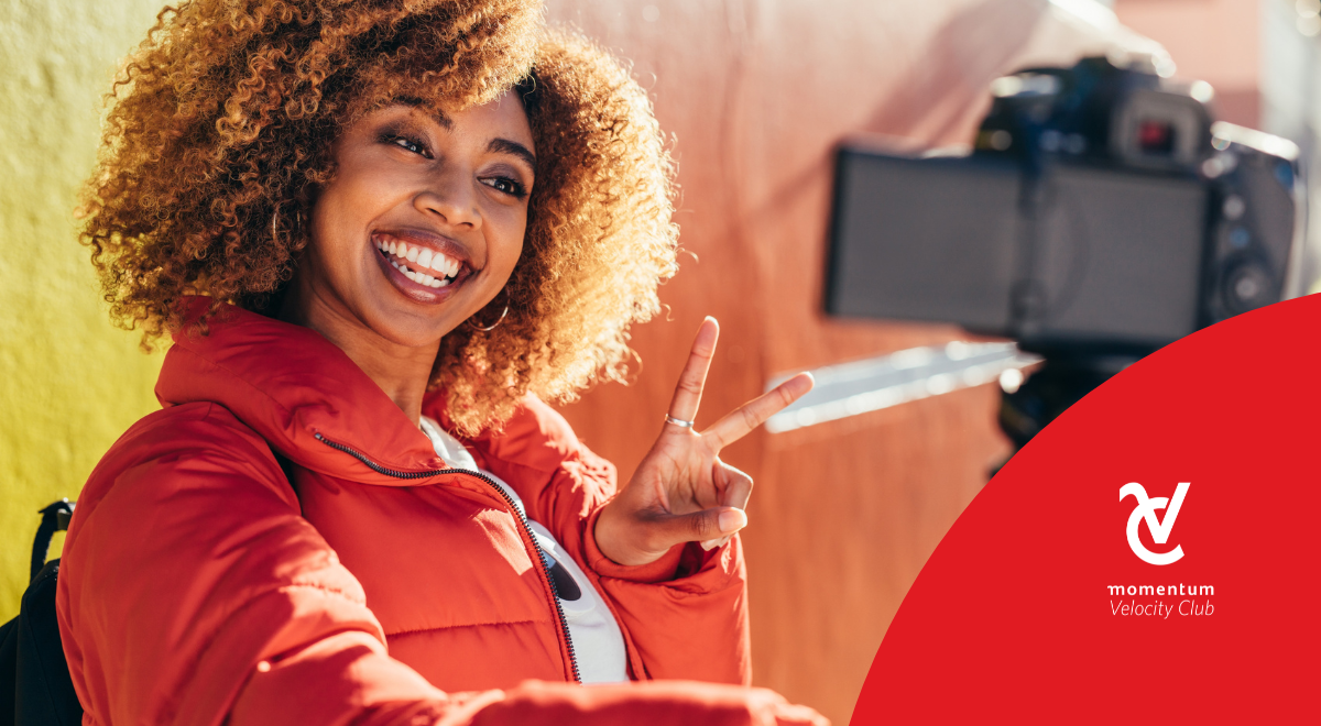 A young woman building her side hustle by filming a social media video.