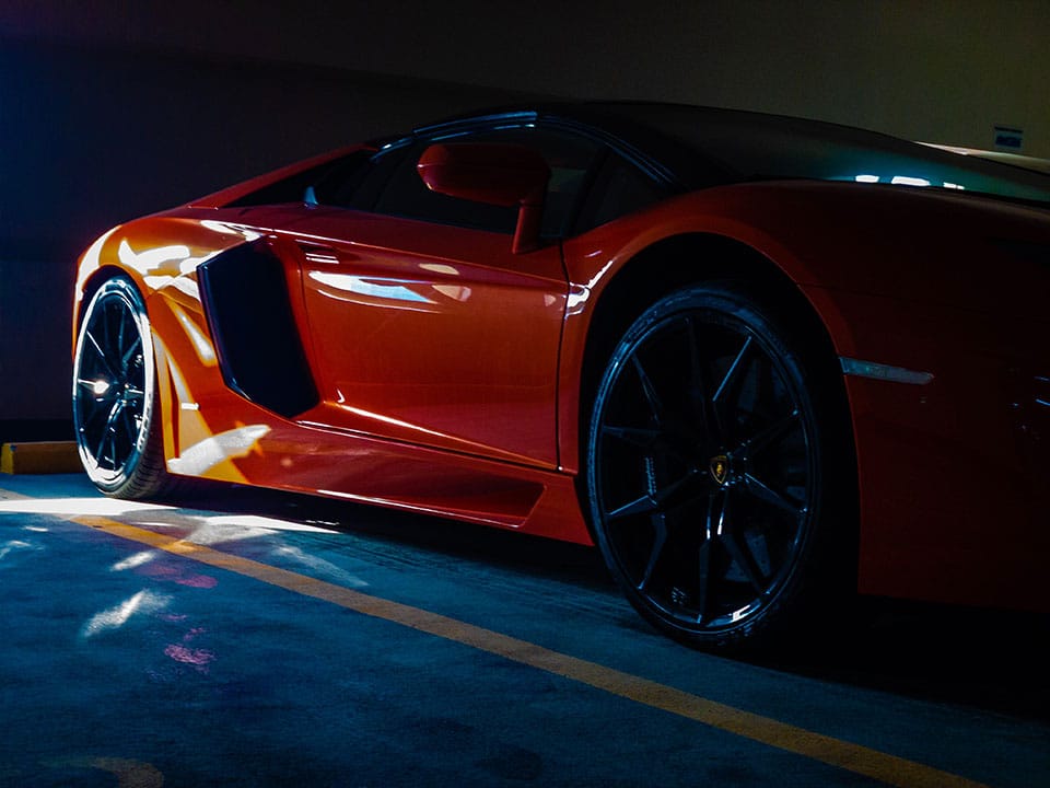 Red Lamborghini parked in a parking lot.