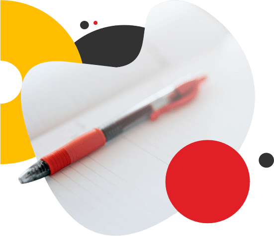 A red pen resting on top of a notebook.